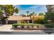 Charming single-story home featuring lush landscaping and a well-manicured lawn on a sunny day at 3007 La Mesa Dr, Henderson, NV 89014