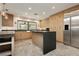 An oversized kitchen with a central island, bar seating and stainless steel appliances at 3007 La Mesa Dr, Henderson, NV 89014
