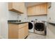 Bright laundry room with stainless steel appliances and ample cabinet space at 3007 La Mesa Dr, Henderson, NV 89014