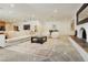 Bright living room featuring a fireplace, modern furniture, and a neutral color palette with patterned rug at 3007 La Mesa Dr, Henderson, NV 89014