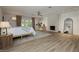 Spacious main bedroom with light wood floors, a fireplace, and french doors leading to the backyard at 3007 La Mesa Dr, Henderson, NV 89014