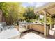 Outdoor kitchen featuring a built-in grill and sink, great for entertaining with a view of lush landscaping at 3007 La Mesa Dr, Henderson, NV 89014