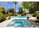 Beautiful in-ground swimming pool and jacuzzi surrounded by lush landscaping at 3007 La Mesa Dr, Henderson, NV 89014