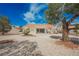Backyard featuring low-maintenance gravel, covered patio, and mature tree, providing shade at 3116 Richland Dr, Las Vegas, NV 89134