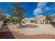 Backyard featuring low-maintenance gravel, covered patio with mature tree creating a relaxing desert landscape at 3116 Richland Dr, Las Vegas, NV 89134