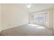 Spacious bedroom with neutral carpet, ceiling fan and a bay window allowing ample natural light at 3116 Richland Dr, Las Vegas, NV 89134