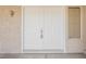 Close-up of a double door entrance, with gold hardware, framed by a sidelight and stucco wall at 3116 Richland Dr, Las Vegas, NV 89134