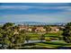 Scenic view from above with homes backing onto a golf course and ponds and with mountains in the background at 3116 Richland Dr, Las Vegas, NV 89134
