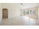 Sunlit living room featuring tile flooring, ceiling fan, slider to back yard, and neutral color palette at 3116 Richland Dr, Las Vegas, NV 89134
