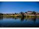 Scenic pond with waterfront homes, green landscaping, and distant mountain views under a clear blue sky at 3116 Richland Dr, Las Vegas, NV 89134