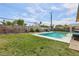 Large backyard showcasing a sparkling pool, privacy fence, and mature landscaping, creating a private retreat at 3140 Sundown Dr, Las Vegas, NV 89169