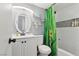 Updated bathroom with a white vanity, decorative mirror, and a tub-shower combo with colorful accents at 3140 Sundown Dr, Las Vegas, NV 89169