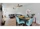 Bright open-plan dining area with laminate wood flooring and seating for four at 3140 Sundown Dr, Las Vegas, NV 89169