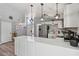Bright kitchen with white cabinetry, stainless steel appliances, and modern pendant lighting at 3140 Sundown Dr, Las Vegas, NV 89169
