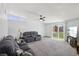 Bright living room with large sliding glass doors, plush gray sofas, and neutral walls at 3140 Sundown Dr, Las Vegas, NV 89169
