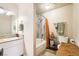 Bright bathroom featuring a shower over tub combination with orange shower curtain at 3151 Soaring Gulls Dr # 1201, Las Vegas, NV 89128