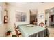 Bright dining area with window, seating for four, and view to the living room and kitchen at 3151 Soaring Gulls Dr # 1201, Las Vegas, NV 89128