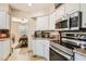 Well-lit kitchen with white cabinetry, stainless steel appliances, and adjacent dining area at 3151 Soaring Gulls Dr # 1201, Las Vegas, NV 89128