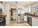 Updated kitchen featuring stainless steel refrigerator, white cabinets, and tile flooring at 3151 Soaring Gulls Dr # 1201, Las Vegas, NV 89128