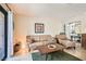 Cozy living room with tan couch, textured rug, natural light, and eclectic wall art at 3151 Soaring Gulls Dr # 1201, Las Vegas, NV 89128