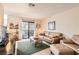 Bright living room featuring tan leather furniture, textured rug, and natural light from sliding glass doors at 3151 Soaring Gulls Dr # 1201, Las Vegas, NV 89128