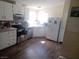 Bright kitchen features white cabinets, modern appliances, tile backsplash, and plank flooring at 3451 Ramona Ln, Pahrump, NV 89048