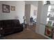 Cozy living room with brown sofa and view into the kitchen and dining area at 3451 Ramona Ln, Pahrump, NV 89048