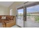 Spacious living room with access to a private balcony offering neighborhood views at 3825 Ormond Beach St # 203, Las Vegas, NV 89129