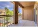 A private outdoor balcony with iron railing and garden views at 3825 Ormond Beach St # 203, Las Vegas, NV 89129