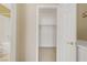 A bedroom closet with shelving and hanging rod and an open, paneled, white door at 3825 Ormond Beach St # 203, Las Vegas, NV 89129