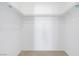 A walk-in closet with white walls, neutral carpet, and metal hanging rods and shelving at 3825 Ormond Beach St # 203, Las Vegas, NV 89129