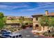 Street view of a multi-Gathering condo building with driveway and desert landscaping at 3825 Ormond Beach St # 203, Las Vegas, NV 89129