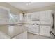 Bright kitchen with white cabinets, stainless steel appliances, and a window view at 3825 Ormond Beach St # 203, Las Vegas, NV 89129