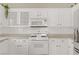 Well-lit kitchen featuring white cabinetry and modern appliances at 3825 Ormond Beach St # 203, Las Vegas, NV 89129