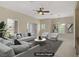 Bright, staged living room with modern ceiling fan, neutral walls, and large windows for natural light at 3825 Ormond Beach St # 203, Las Vegas, NV 89129