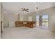 Open living room featuring a leather sofa, balcony access, and a chandelier at 3825 Ormond Beach St # 203, Las Vegas, NV 89129