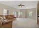 Spacious living room with large leather sofa, bright windows and chandelier at 3825 Ormond Beach St # 203, Las Vegas, NV 89129