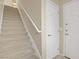 Clean staircase with carpet runner and white handrail leads to the upper levels of the home at 3825 Ormond Beach St # 203, Las Vegas, NV 89129