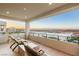 Relaxing covered balcony with outdoor seating and scenic neighborhood view at 394 Solitude Peak Ln, Henderson, NV 89012