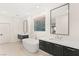 Bright bathroom features a modern tub and stylish vanities at 394 Solitude Peak Ln, Henderson, NV 89012