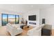 Bright living room featuring hardwood floors, modern fireplace, balcony access, and contemporary furnishings at 394 Solitude Peak Ln, Henderson, NV 89012