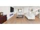 Contemporary living space with hardwood floors, a fireplace, and an open layout leading to the kitchen at 394 Solitude Peak Ln, Henderson, NV 89012