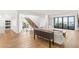 Open-concept living area with hardwood floors, modern staircase, and a balcony offering scenic views at 394 Solitude Peak Ln, Henderson, NV 89012