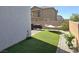 Relaxing backyard area with artificial turf, a hammock, and brick pavers at 4109 Cloudless Ave, North Las Vegas, NV 89081