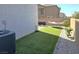 Backyard featuring artificial turf, a hammock, and low-maintenance landscaping at 4109 Cloudless Ave, North Las Vegas, NV 89081