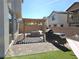 Beautiful backyard featuring a patio area with pergola, barbecue, grill, hammock, and manicured artificial grass at 4109 Cloudless Ave, North Las Vegas, NV 89081