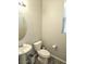 Cozy bathroom features a pedestal sink, a toilet, and a window for natural light at 4109 Cloudless Ave, North Las Vegas, NV 89081
