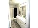 Well-lit bathroom with a vanity, double sinks, modern fixtures, and a shower-tub combo at 4109 Cloudless Ave, North Las Vegas, NV 89081