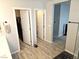 Bathroom view showcasing closet and doorway, wood look tile flooring and neutral wall color at 4109 Cloudless Ave, North Las Vegas, NV 89081