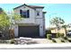 Charming two-story home features a brown garage door and desert landscaping at 4109 Cloudless Ave, North Las Vegas, NV 89081